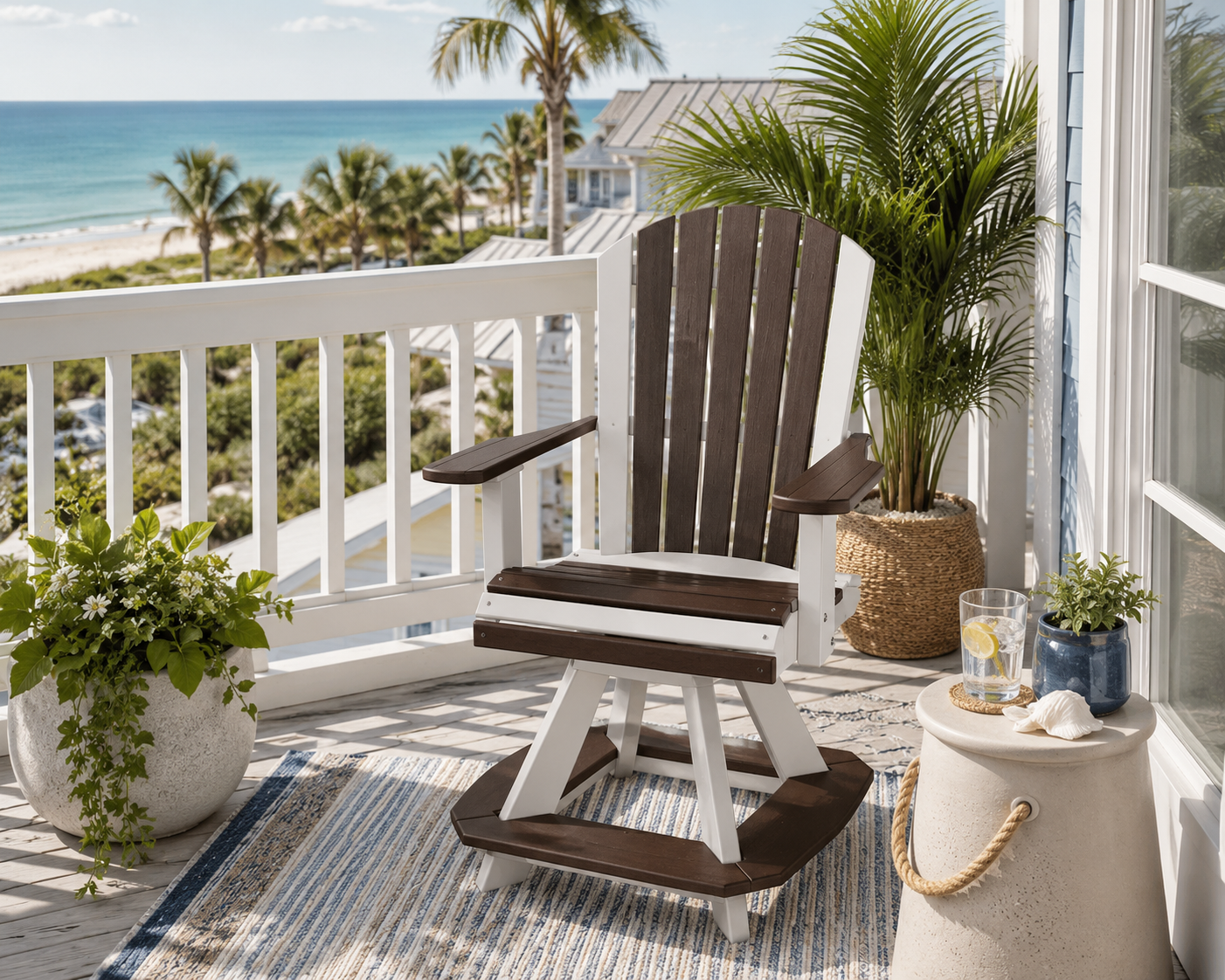 Coastal balcony with a two-tone poly Adirondack swivel chair overlooking the beach, accented by tropical plants and décor.
