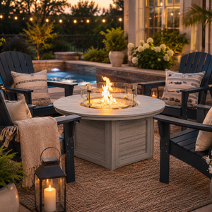 Modern poly fire pit and poly Adirondack chairs create a cozy backyard gathering space by the pool