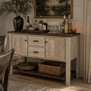 Rustic farmhouse dining room with a whitewashed buffet styled as a home bar, featuring glassware, spirits, and warm decor.