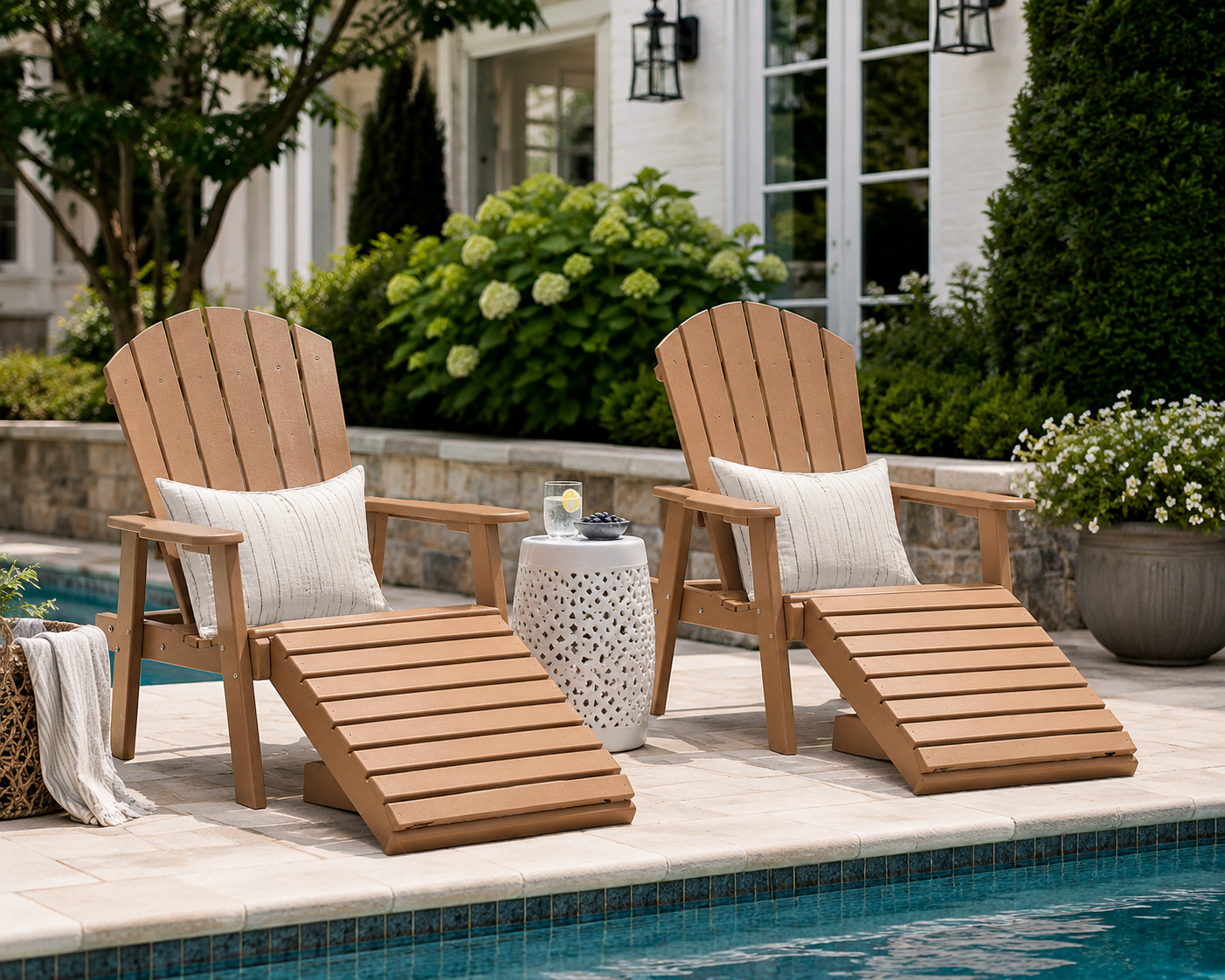 Weathered wood poly Adirondack chair with matching ottoman beside a backyard pool, styled for relaxing outdoor living.