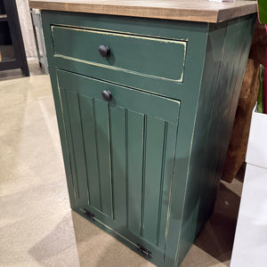 Dark green distressed tilt-out trash bin cabinet with stained countertop