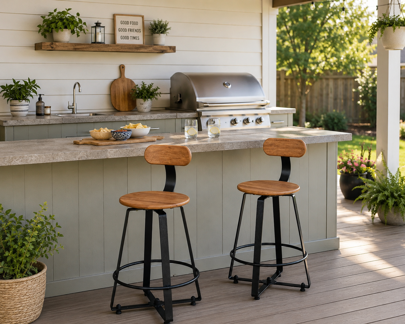 Outdoor swivel bar stools with wood-look seats and black metal frames at a backyard outdoor kitchen with a covered patio.