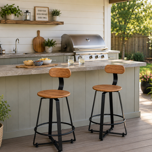 Outdoor swivel bar stools with wood-look seats and black metal frames at a backyard outdoor kitchen with a covered patio.