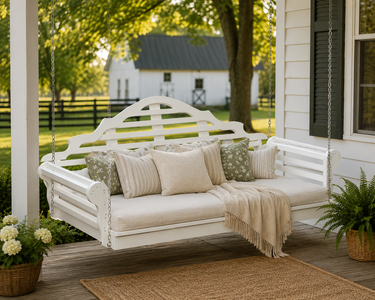 Waterproof white poly porch swing bed with neutral cushions on a classic farm porch for cozy outdoor living