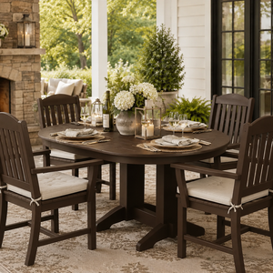 Dark brown poly oval dining table with four armchairs on a covered outdoor patio for stylish entertaining.