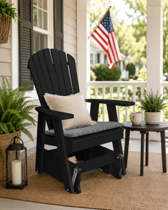 Weatherproof black poly adirondack gliding chair on a traditional front porch with the American flag.