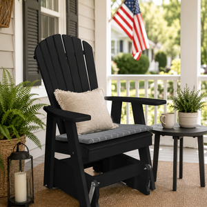 Weatherproof black poly adirondack gliding chair on a traditional front porch with the American flag.
