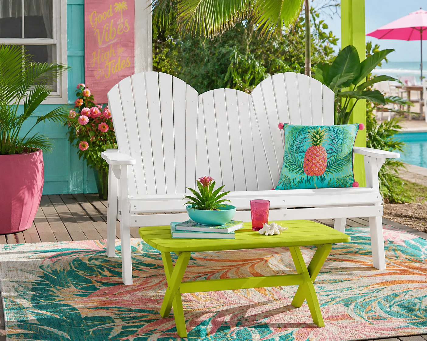 White poly outdoor loveseat and lime green coffee table on a tropical patio for colorful outdoor living