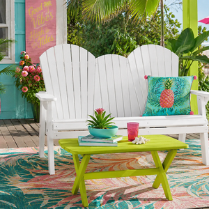 White poly outdoor loveseat and lime green coffee table on a tropical patio for colorful outdoor living