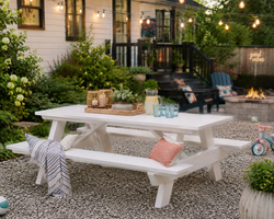 White recycled poly picnic table with attached benches on a patio, designed for outdoor dining, family gatherings, and low-maintenance entertaining