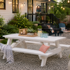 White recycled poly picnic table with attached benches on a patio, designed for outdoor dining, family gatherings, and low-maintenance entertaining