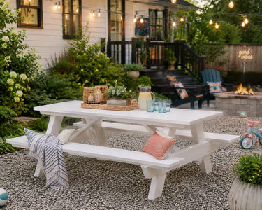White recycled poly picnic table with attached benches on a patio, designed for outdoor dining, family gatherings, and low-maintenance entertaining