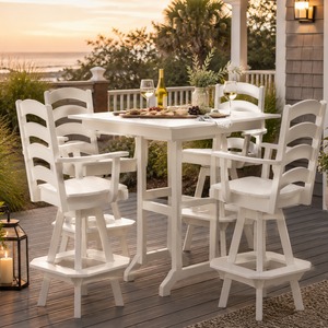 White poly swivel bar dining set on a coastal deck at sunset with wine, charcuterie, and ocean views.
