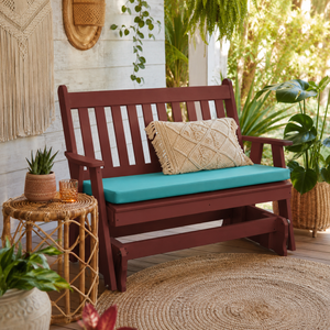 Weather proof poly outdoor glider bench with aqua cushion on a tropical porch, styled for relaxing outdoor living.