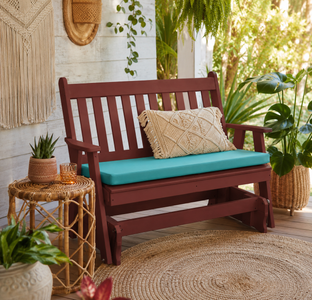 Weather proof poly outdoor glider bench with aqua cushion on a tropical porch, styled for relaxing outdoor living.